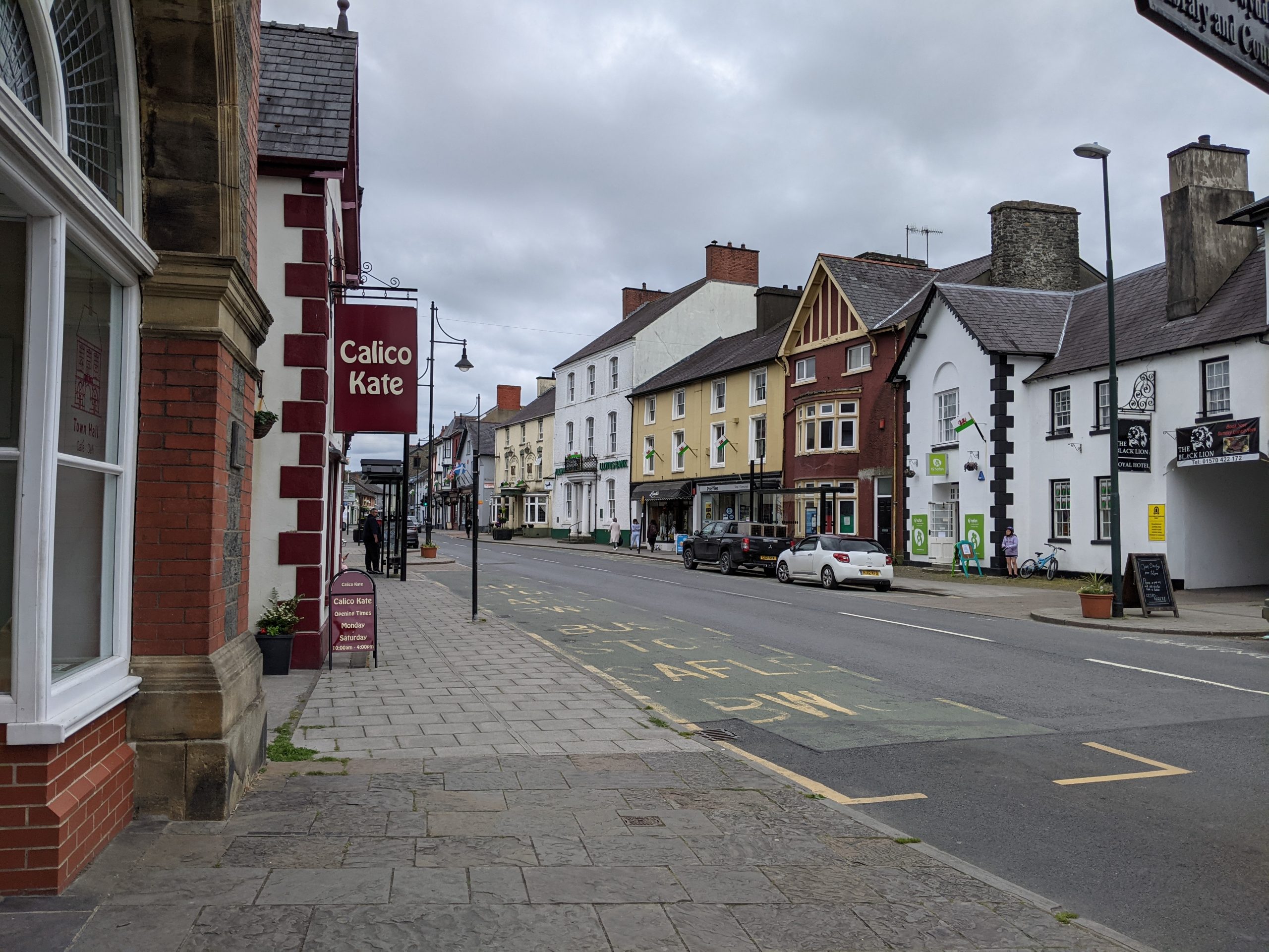 Street in town centre lined with colourful historic houses and shops
