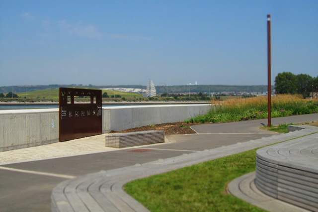 A seafront promeade with seating and a bird hide