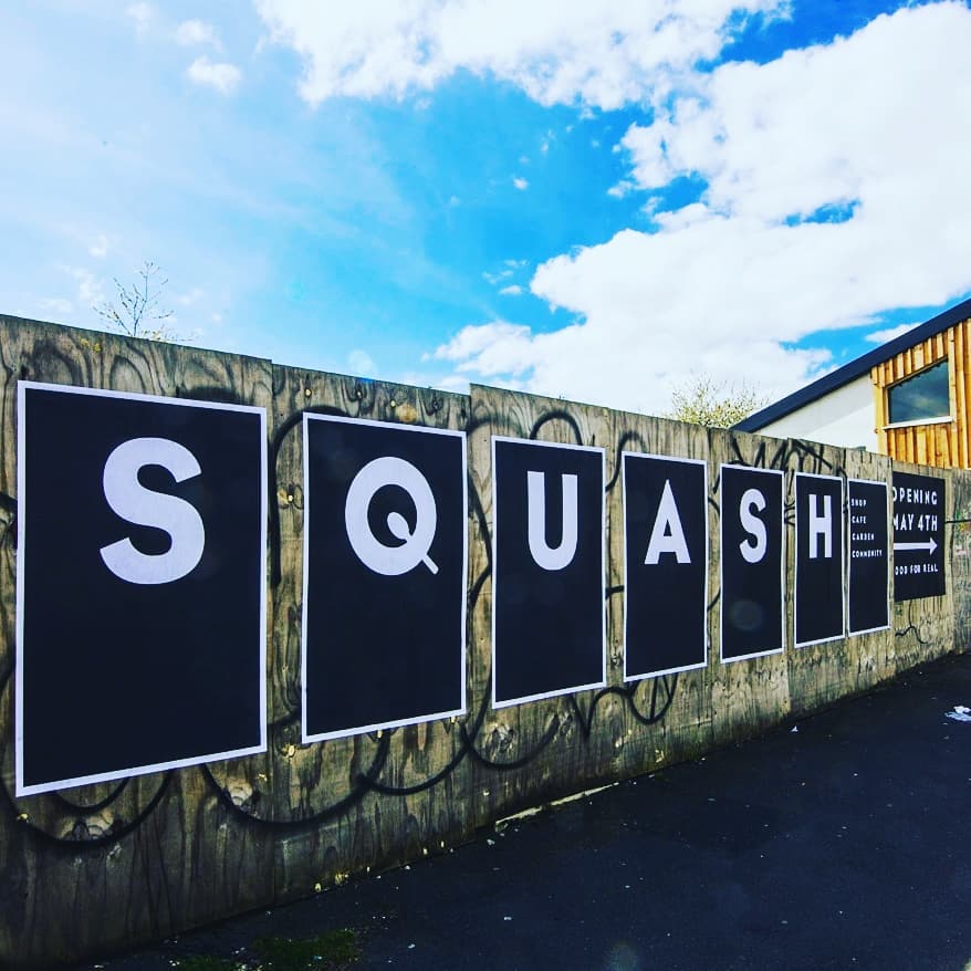 Posters on wall with letters spelling SQUASH